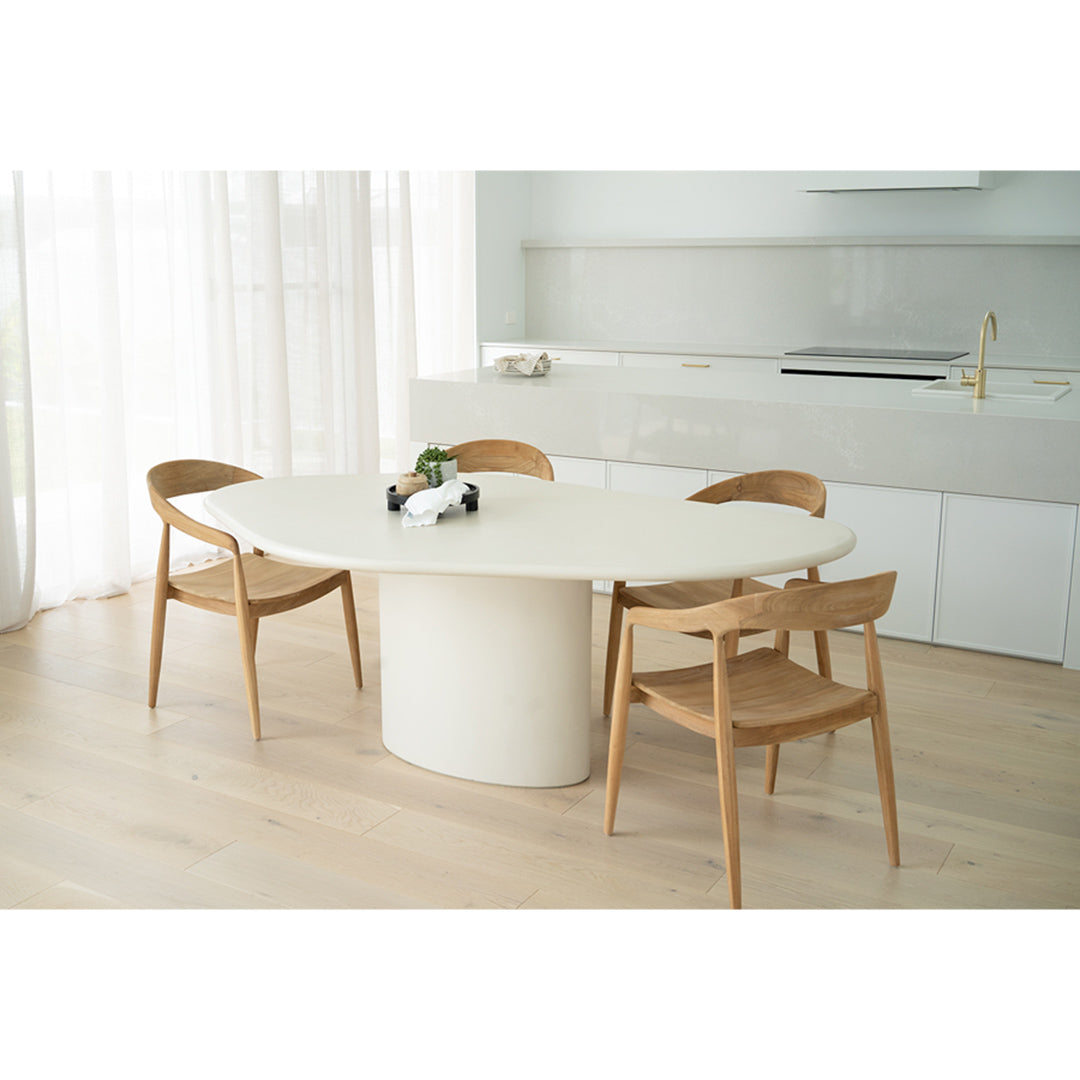 Dining room lifestyle view of Rigby Armchair – Natural around modern oval white table.