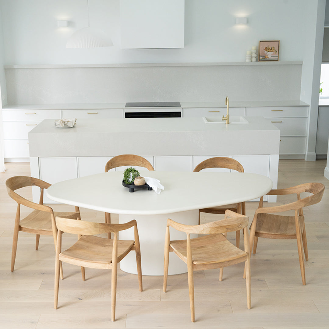 Overhead lifestyle view of Rigby Armchair – Natural paired with dining table in bright kitchen space.