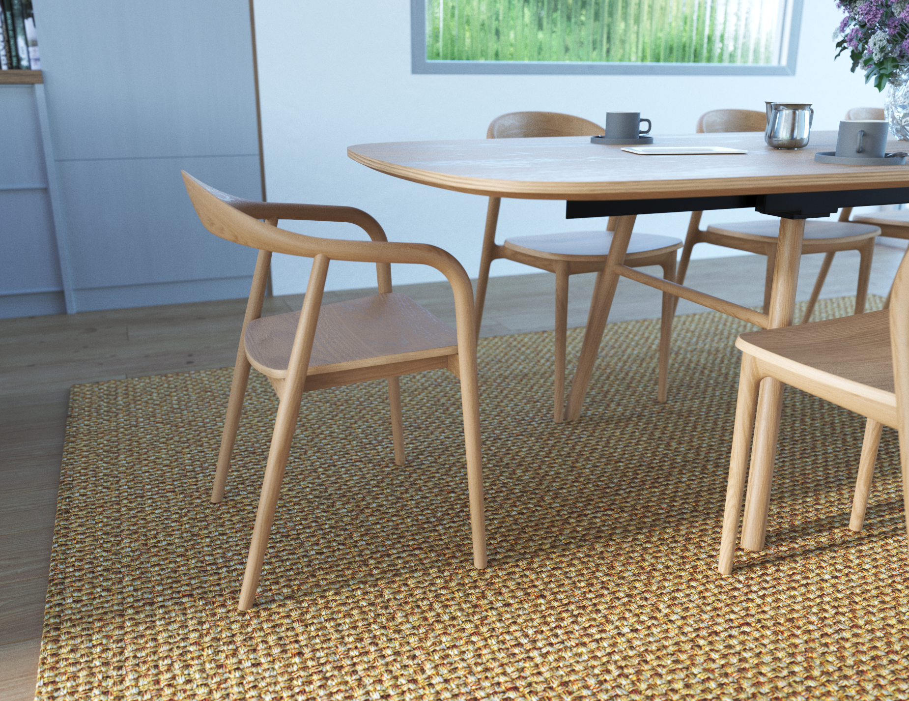 Natural wooden armchair in a dining setting on a natural rug.