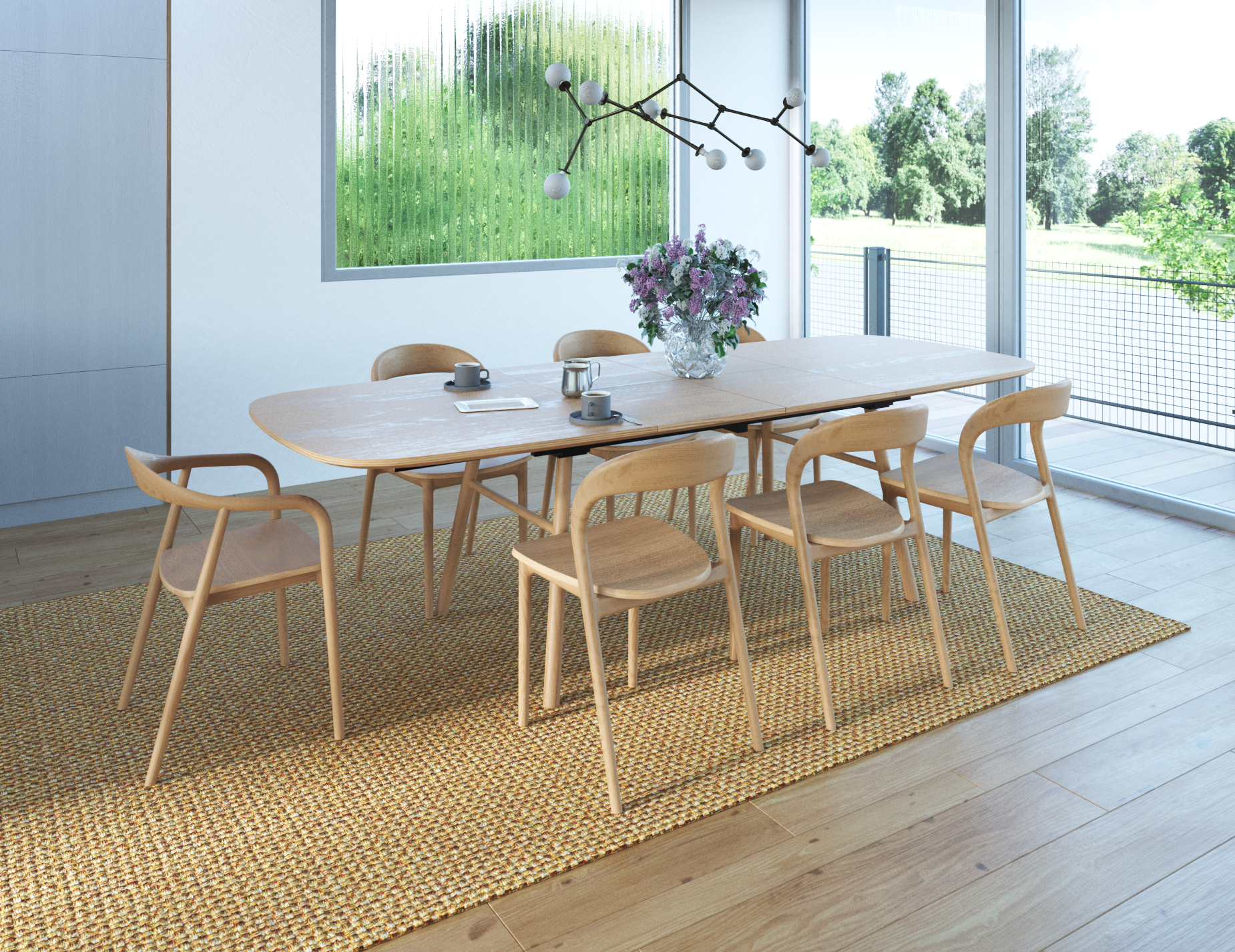Natural wooden armchair in a dining setting with flowers and coffee mugs on the wooden table.