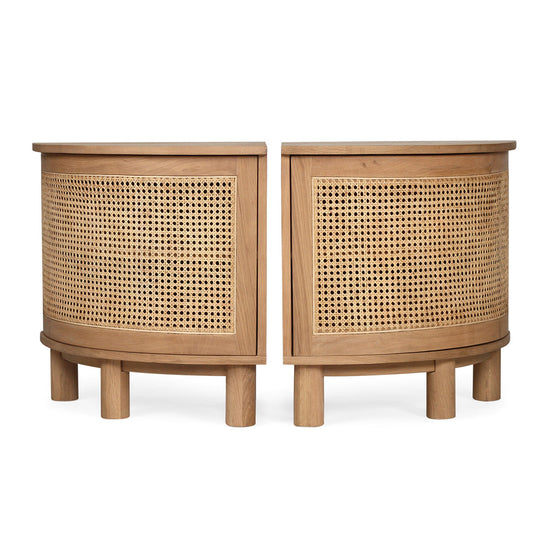Side‑by‑side angled view of Iluka Bedside Tables – Natural (Pair) on white background with curved cane fronts and round oak legs