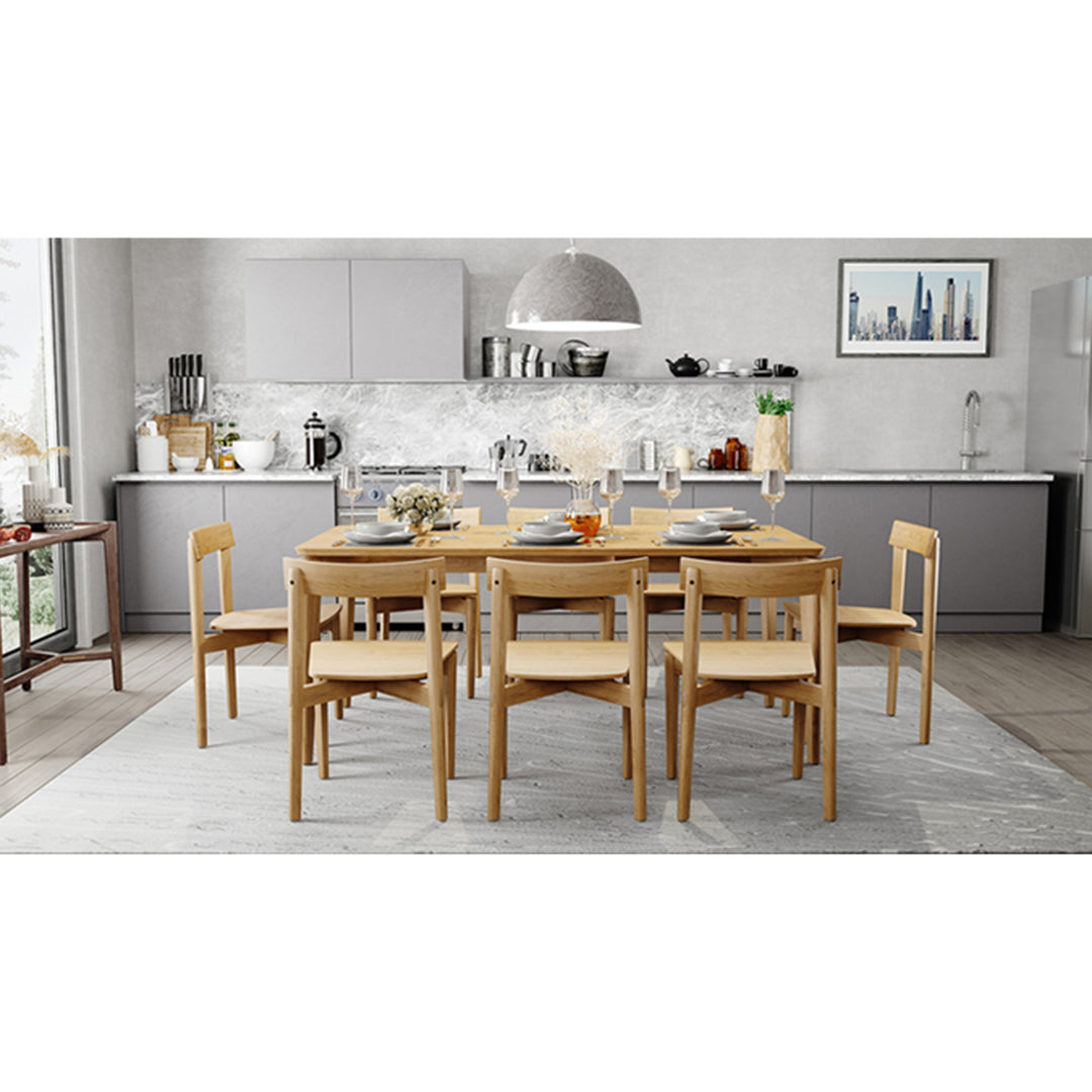 Lifestyle scene with Jude Dining Chairs – Natural arranged around oak dining table in a bright modern interior