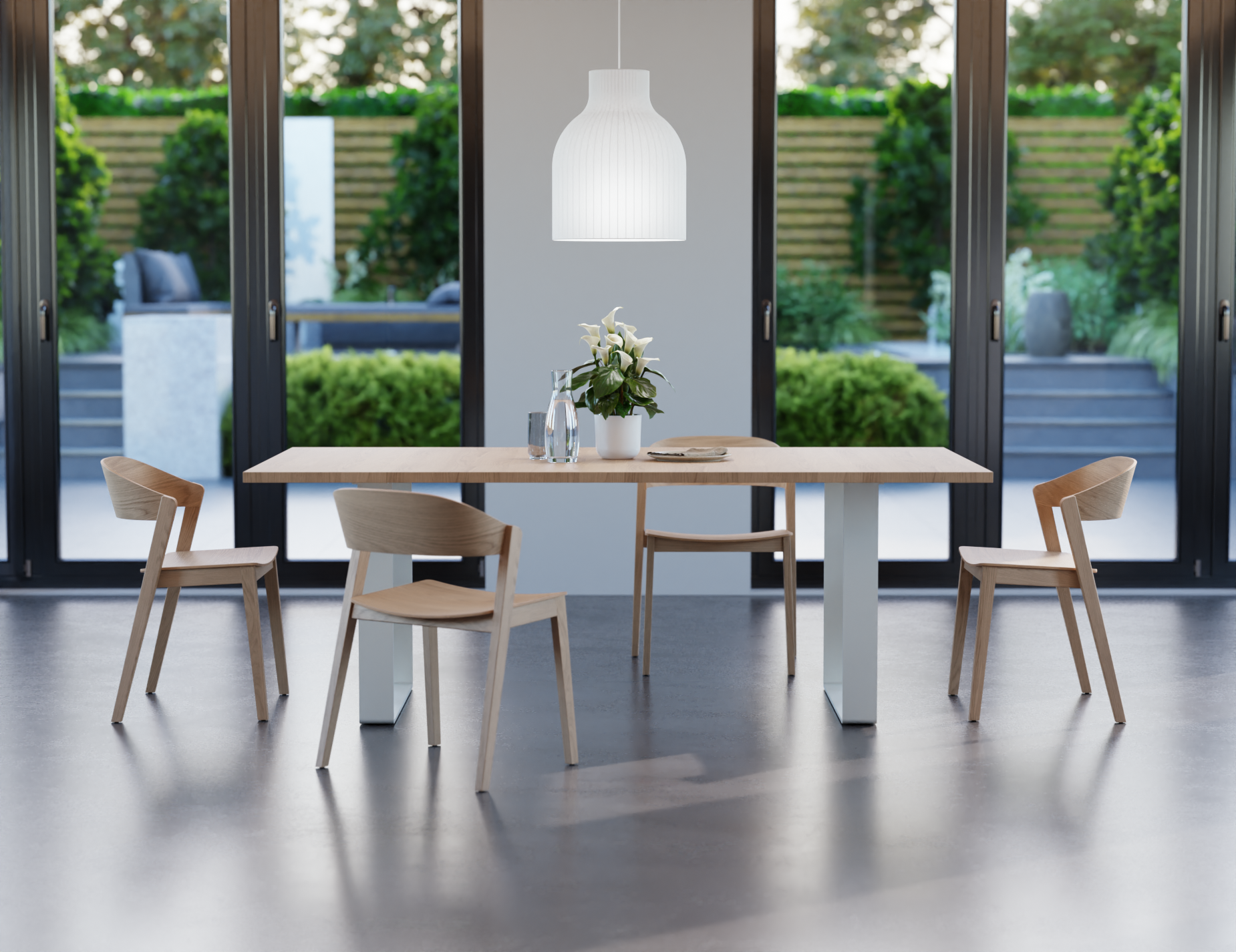 Natural wood dining chairs in a modern dining room with a wooden table with white legs looking outside to a large courtyard.