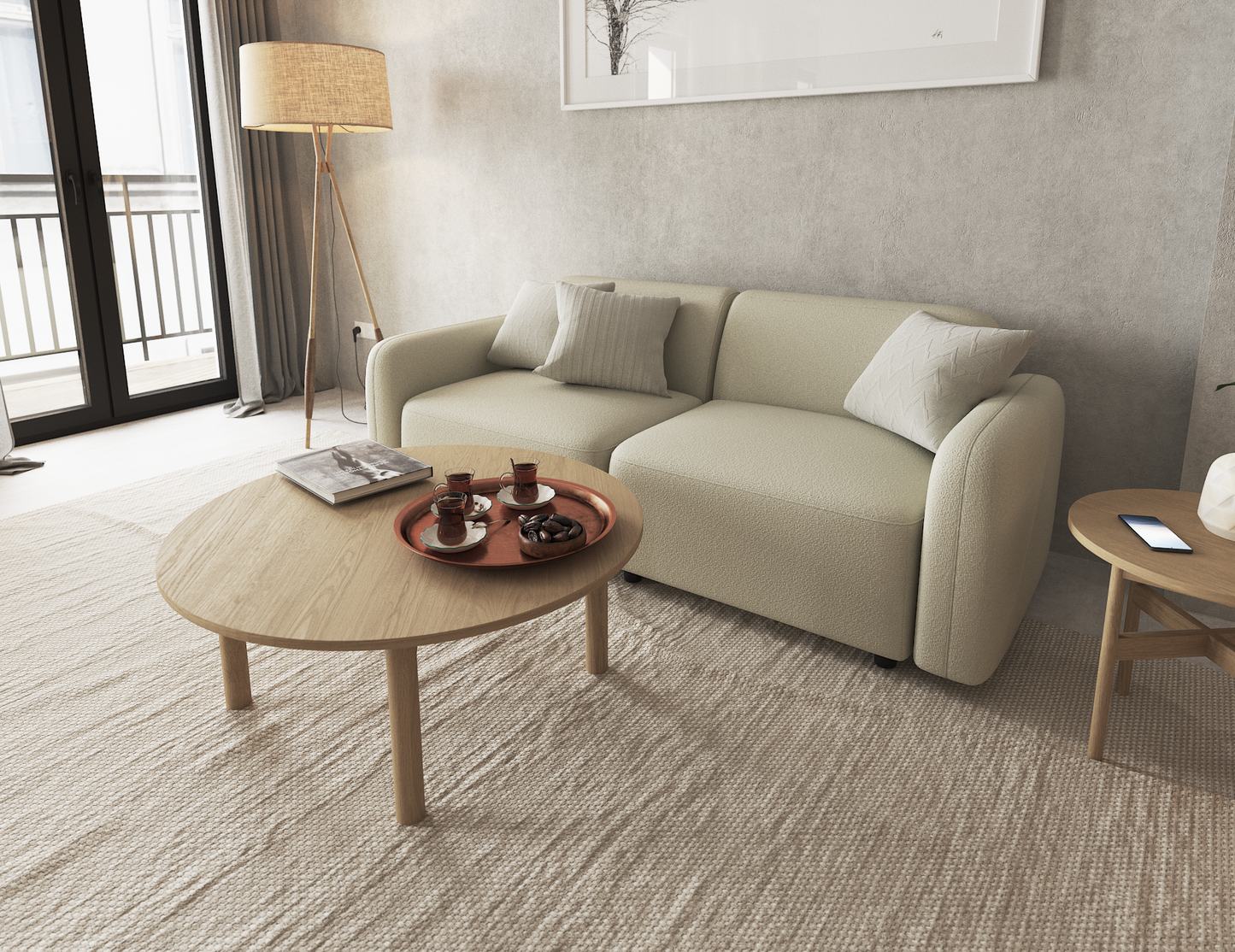 Nordica round wooden coffee table in natural oak finish next to a beige couch on a beige rug.