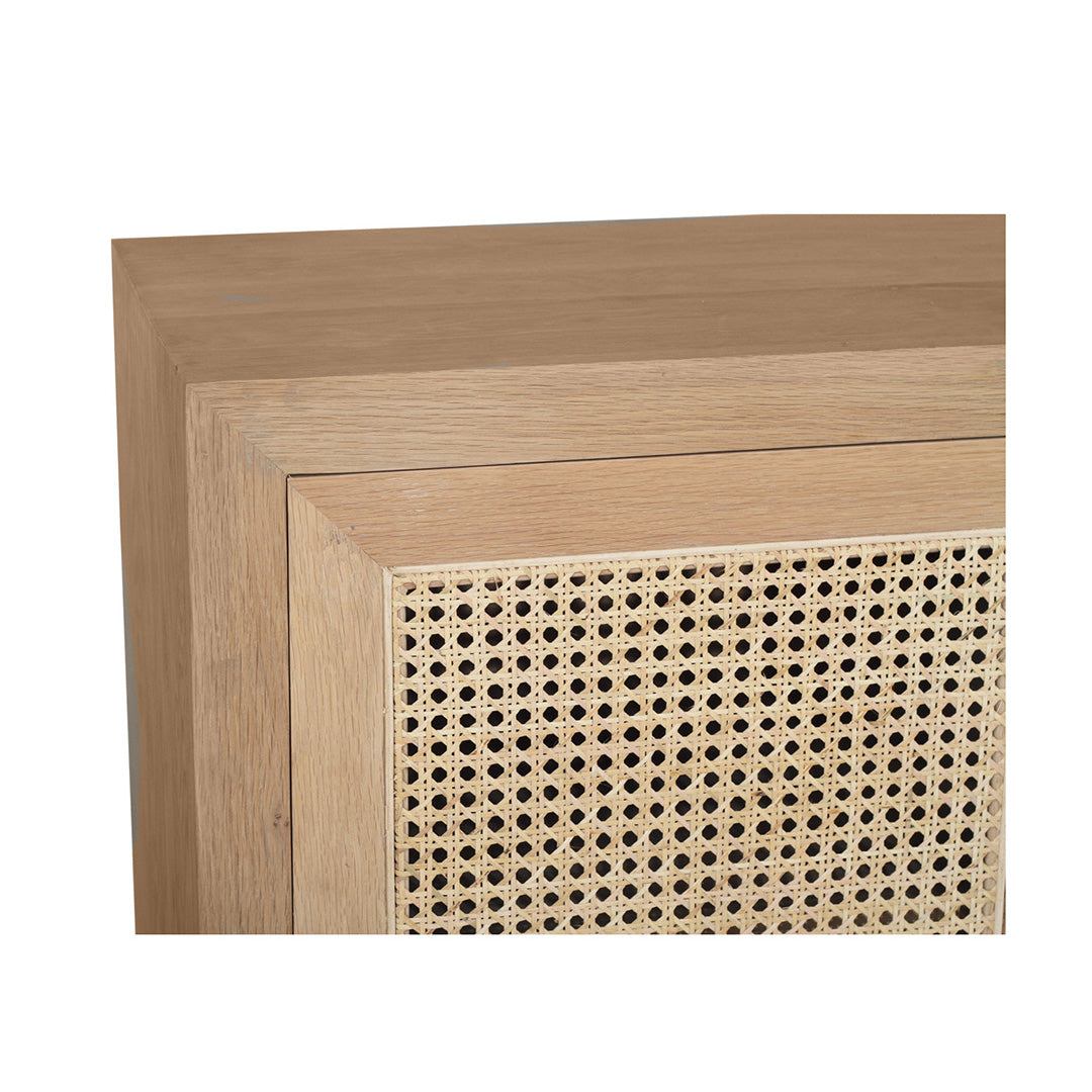 Close-up angled view of Iluka Sideboard - Two Door in natural oak with woven rattan panel detail.