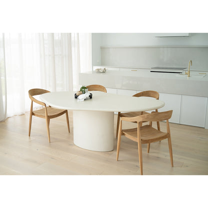 Dining room lifestyle view of Rigby Armchair – Natural around modern oval white table.