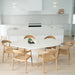 Overhead lifestyle view of Rigby Armchair – Natural paired with dining table in bright kitchen space.