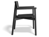 Side profile of Andi Armchair Black solid wood chair, highlighting smooth rounded armrests, angled back support, contoured seat, and minimalist Scandinavian design with a matte black finish on a neutral background.