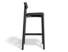 Side profile view of Andi Bar Stool - Black - 75 cm Seat Height, isolated on a white background, showcasing solid wood frame, integrated footrest, and minimalist modern design.