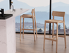 Close-up view of Andi Bar Stool - Natural - 66 cm Seat Height stools beside a marble kitchen island, highlighting craftsmanship, light wood tones, and modern minimalist styling.