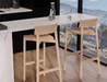 Two Andi Bar Stool - Natural - 75 cm Seat Height stools placed at a modern kitchen counter, showcasing clean lines, sturdy frame, and airy contemporary space.