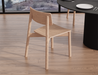 Bright interior dining setup with natural light and wooden table paired with Andi Dining Chair Natural in a contemporary home.
