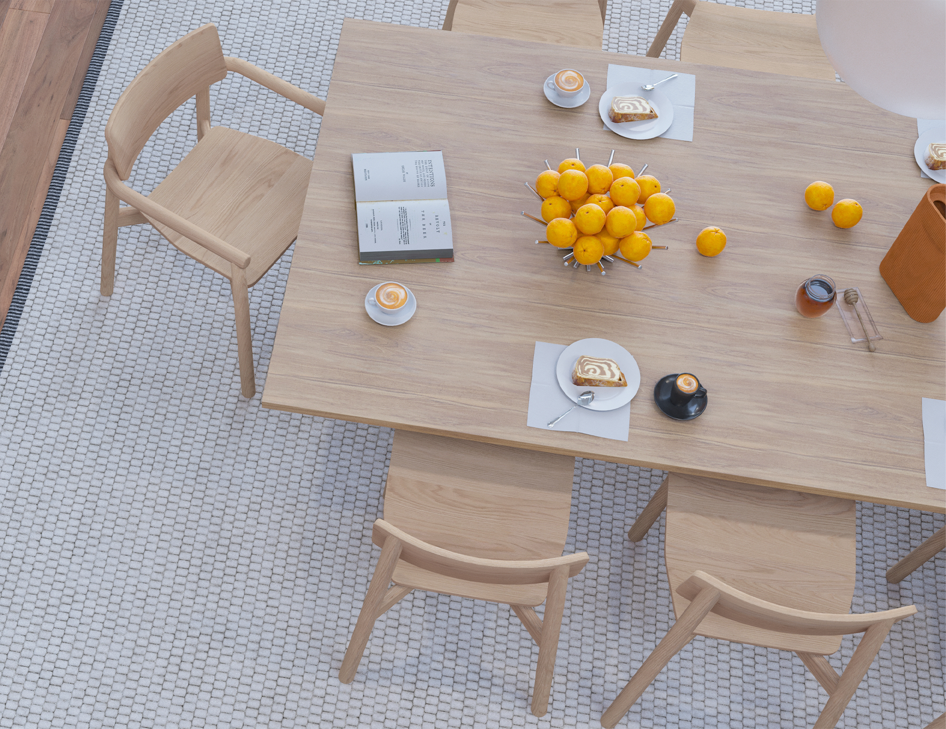 Top view breakfast dining setup with large wooden table, coffee cups, pastries, and oranges centerpiece, surrounded by Andi Dining Chair Natural.