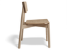 Side profile of Andi Dining Chair Natural highlighting sculpted seat and backrest in solid wood, minimalist furniture design.