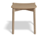 Front view of Andi Low Stool Natural 45 cm Seat Height solid oak stool with curved seat and rounded legs, minimalist Scandinavian design on white background.