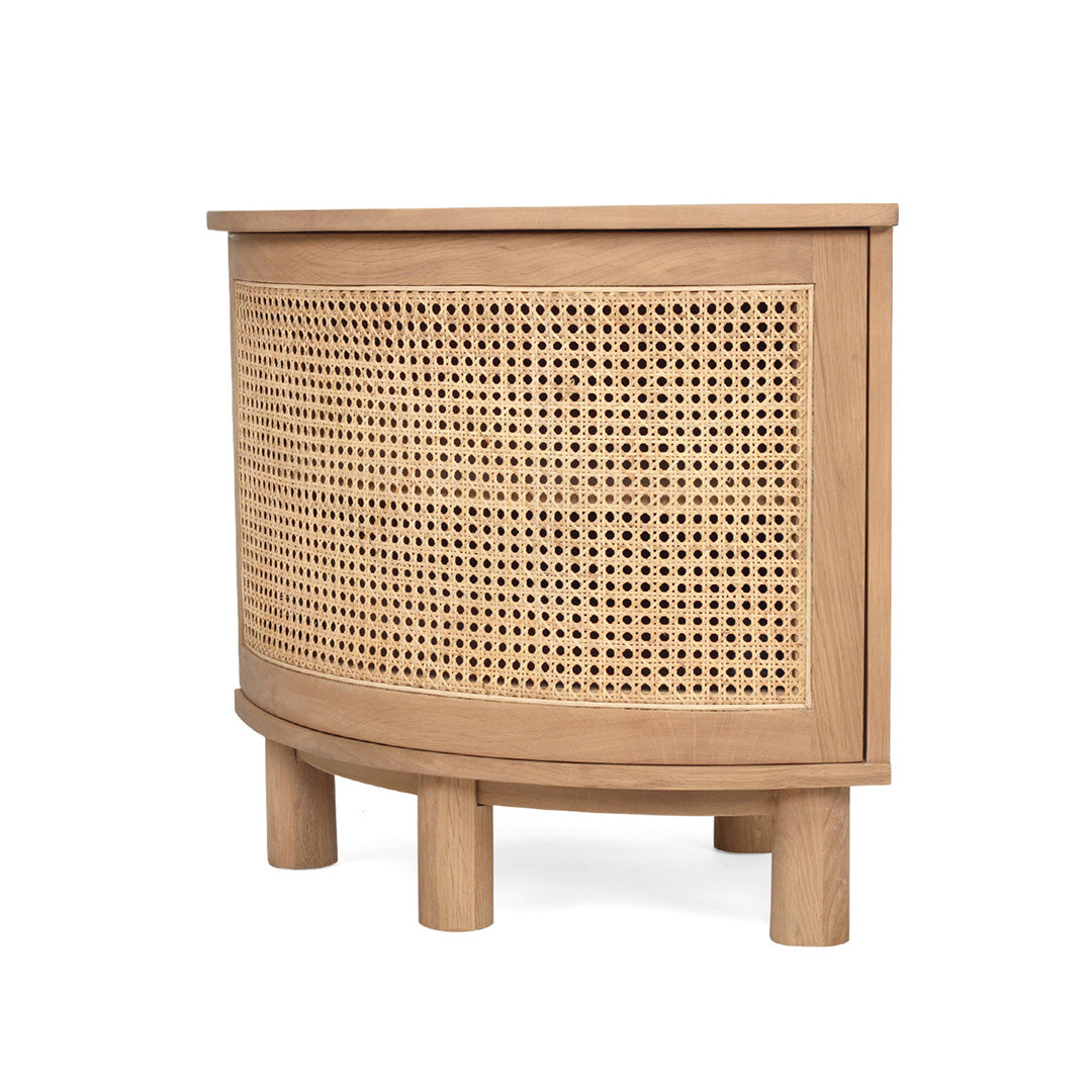 Angled side view of Iluka Bedside Table – Natural highlighting curved cane front and rounded oak base on white background