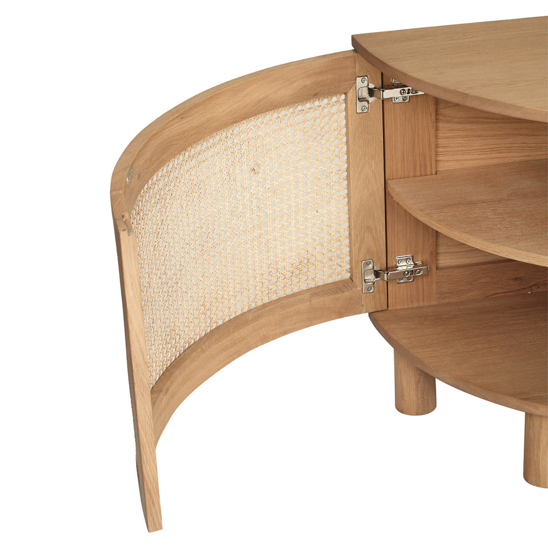 Close‑up open door detail of Iluka Bedside Table – Natural showing curved cane panel, hinges and rounded oak shelves