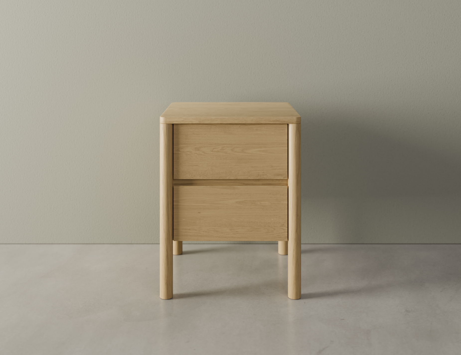 Front view of bedside table in natural wood finish with two drawers, rounded edges and legs on a polished concrete floor.