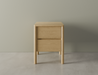Front view of bedside table in natural wood finish with two drawers, rounded edges and legs on a polished concrete floor.