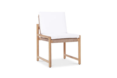 Angled view of Esperance Outdoor Dining Chair with teak base, woven rope seat, and plush white cushions.