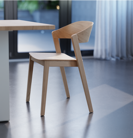 Wooden dining chair in natural ash finish on a polished concrete floor.