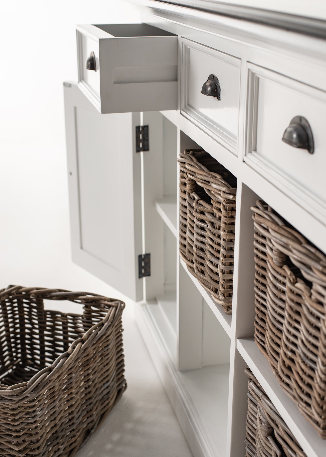 Close-up of the Halifax Contrast Buffet with drawers open, doors open and rattan baskets displayed in the storage compartments.