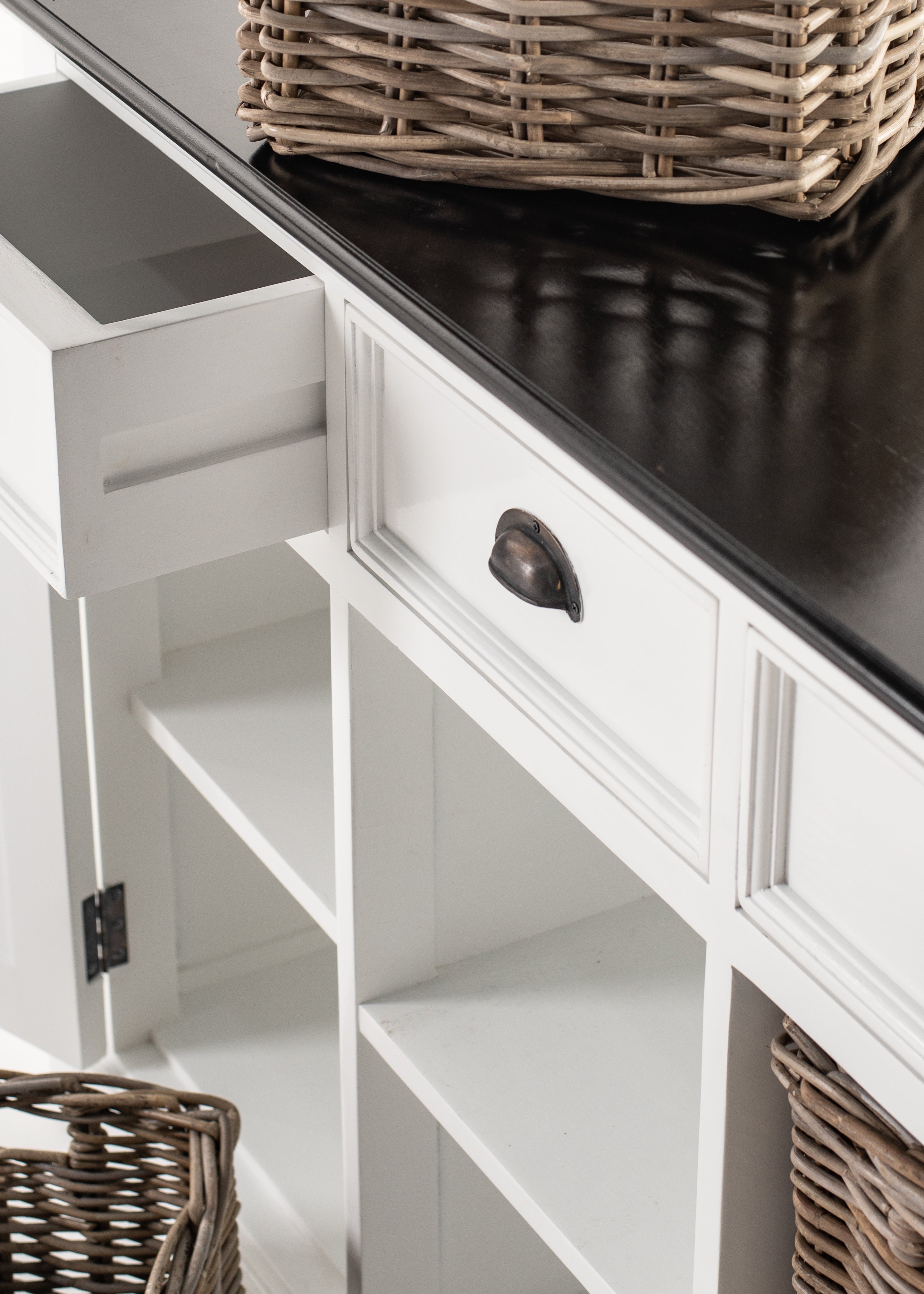 Close-up of rattan storage baskets with the Halifax Contrast Buffet drawer and white painted frame in the background.