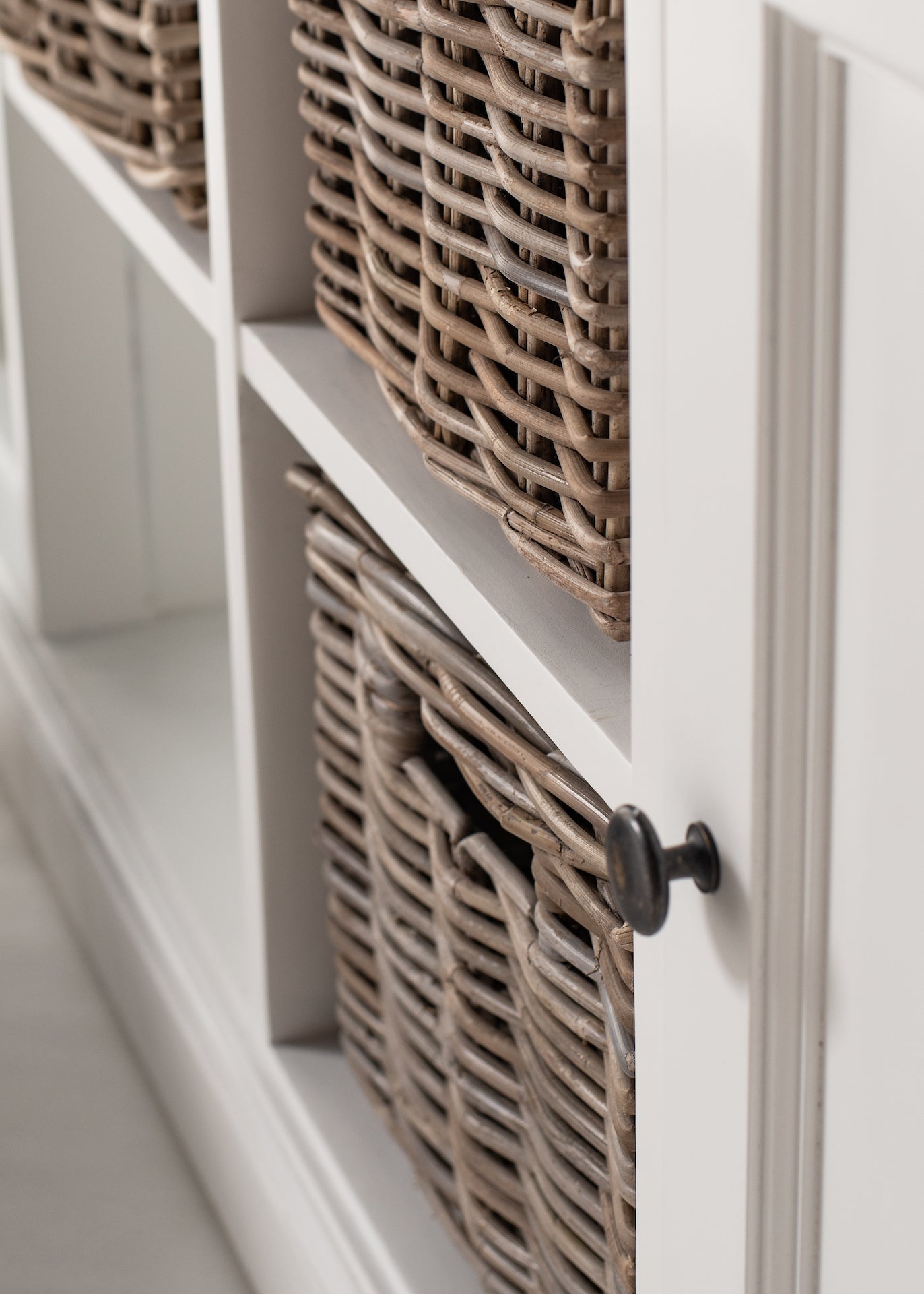 Close-up of rattan baskets fitted into the open shelving of the Halifax Contrast Buffet.