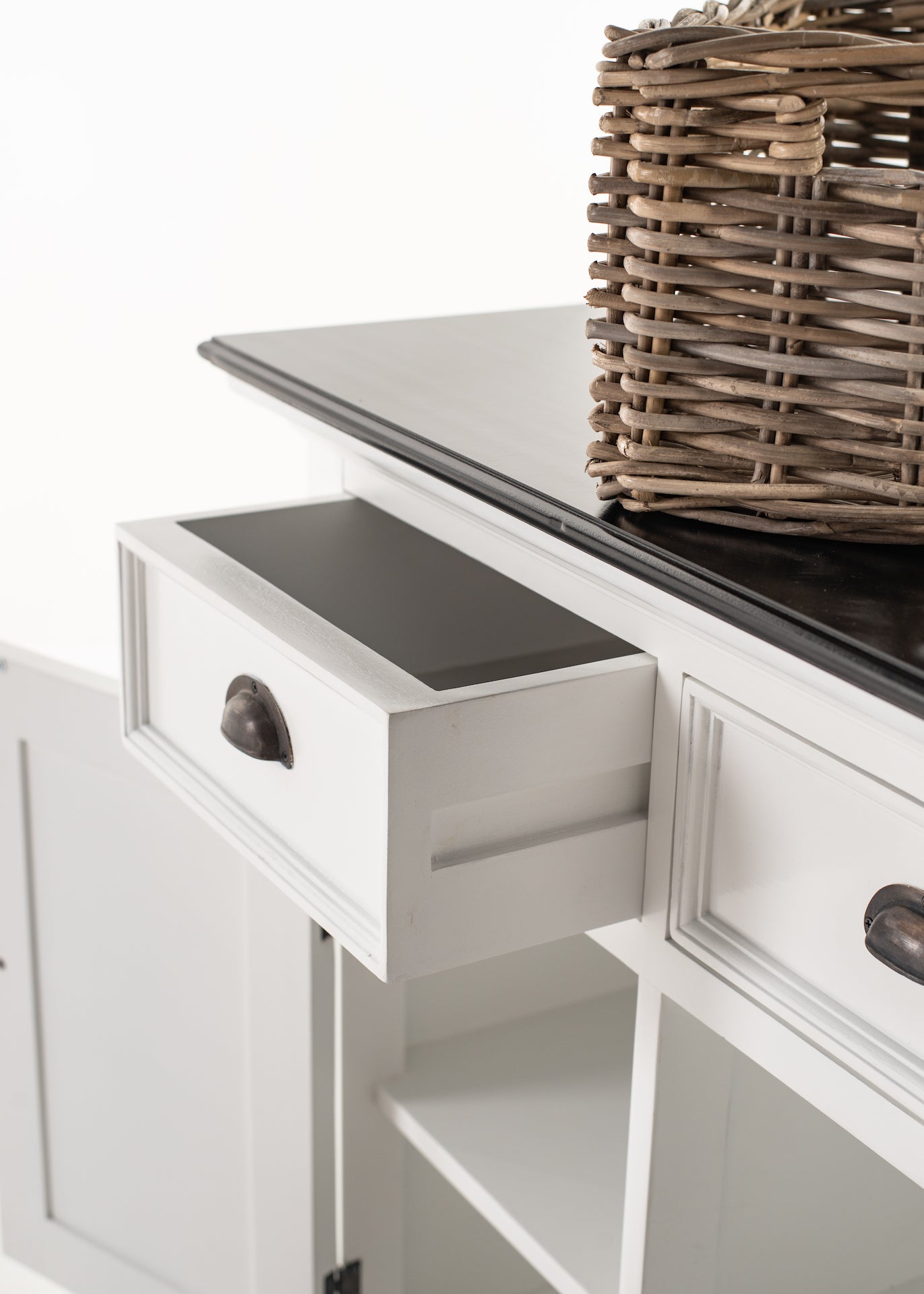 Detail view of an open drawer and rattan basket on the Halifax Contrast Buffet with black timber top.