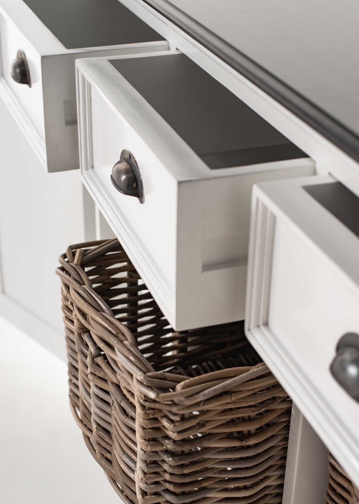 Close-up of multiple open drawers on the Halifax Contrast Buffet with rattan baskets in the shelves below.