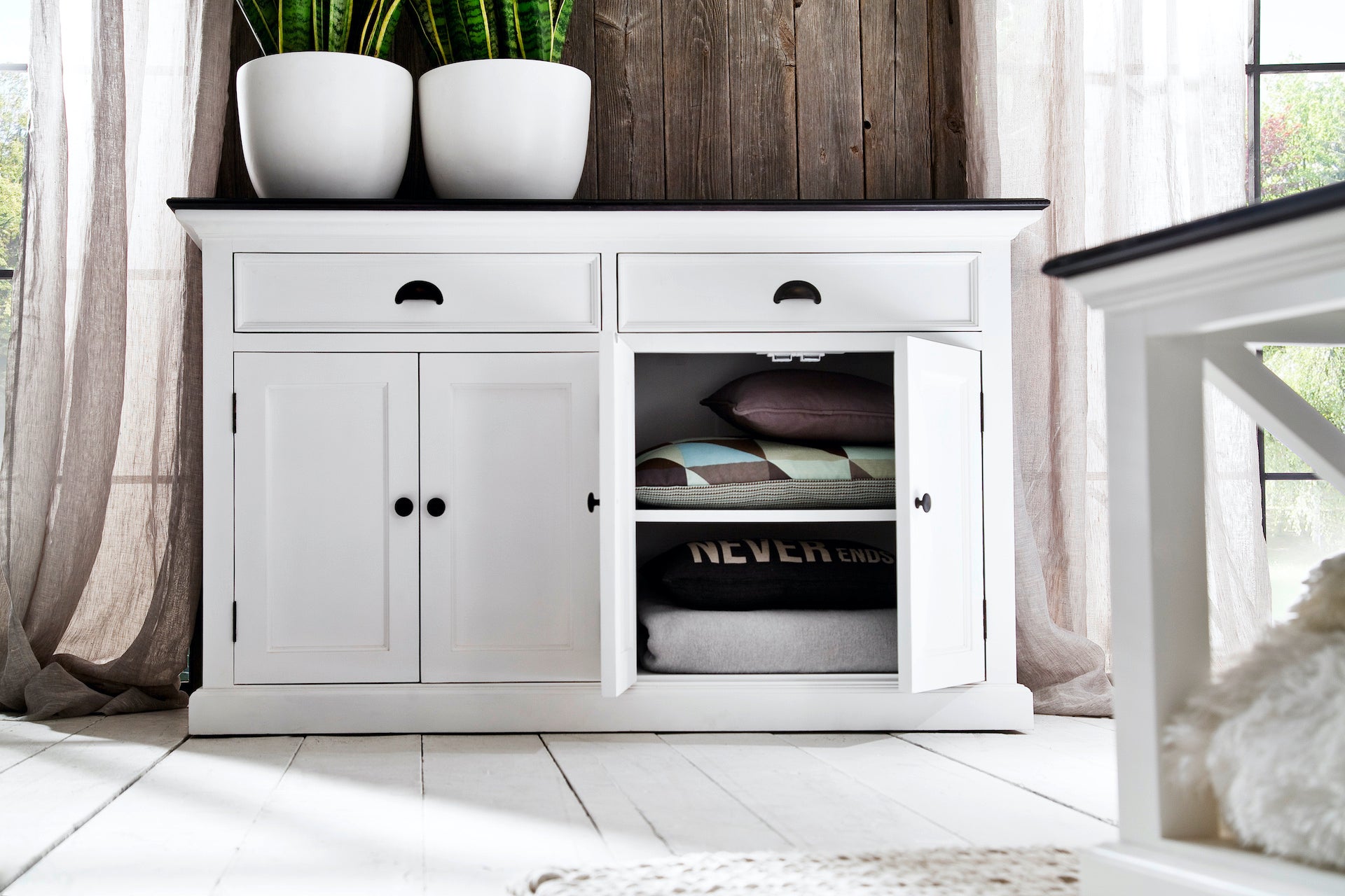 Front view of the Halifax Contrast Classic Buffet with plants on top and one cupboard door open.