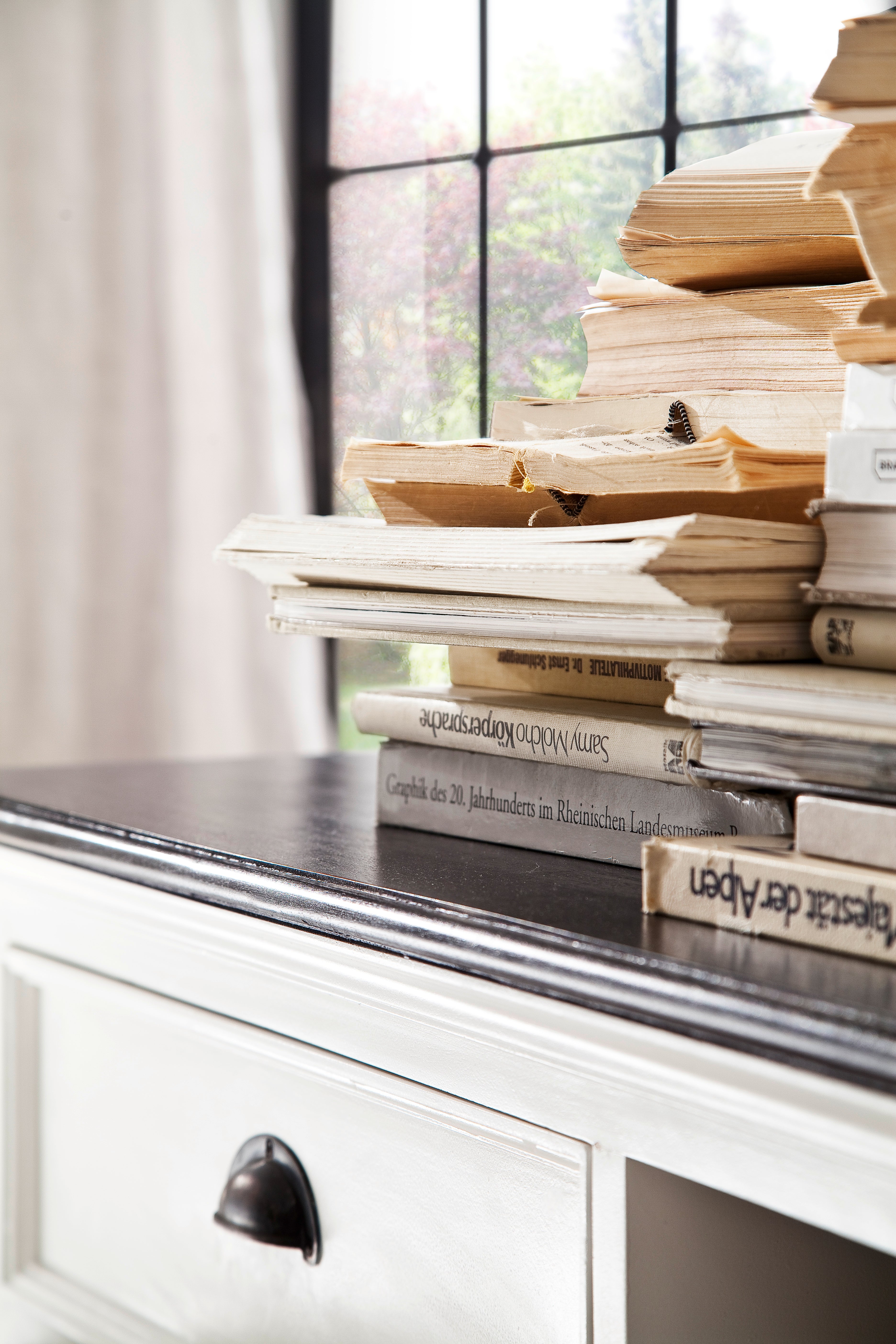 Close-up of books stacked on the dark timber top of the Halifax Contrast Large Entertainment Unit.