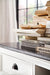 Close-up of books stacked on the dark timber top of the Halifax Contrast Large Entertainment Unit.