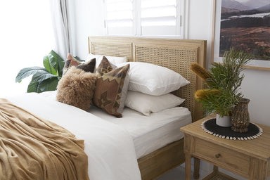 Hamilton Cane Bed Weathered Oak double bed front perspective showing full frame, woven cane headboard, slatted base, and elegant turned legs in a minimalist studio setting.