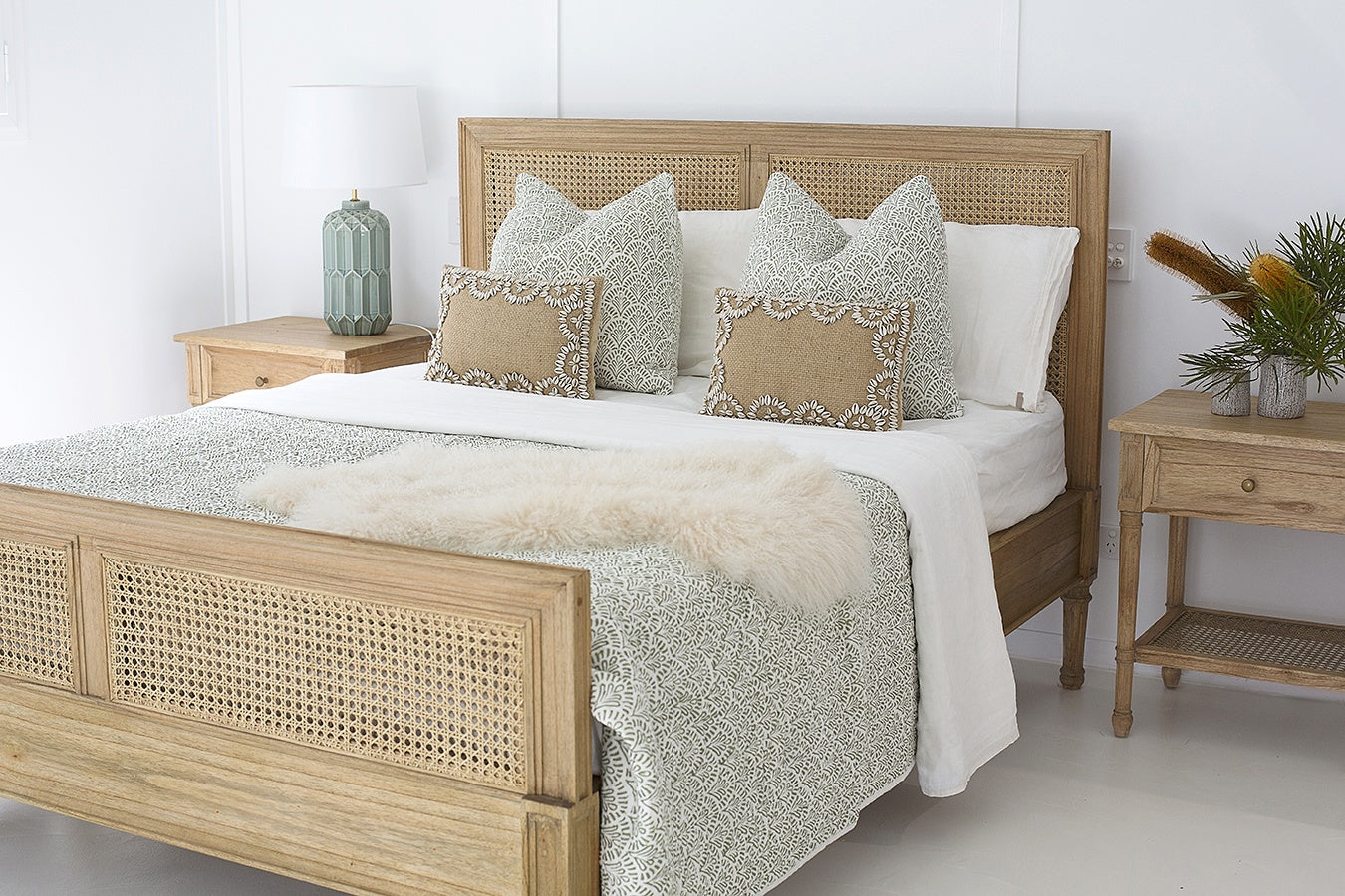 Hamilton Cane Super King Bed with cane footboard and headboard styled with patterned cushions in a relaxed coastal bedroom