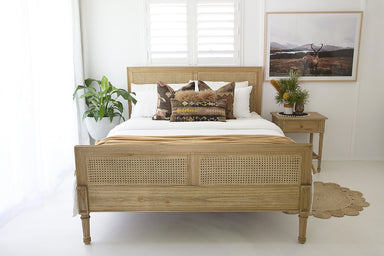 Hamilton Cane Super King Bed in Weathered Oak styled in a bright coastal bedroom with natural rattan cane headboard and footboard