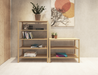 A 2 tier and 4 tier bookshelf side by side made from American oak with assorted books and vases displayed on them with a painting on the wall behind.