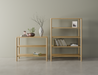 A 2 tier and 4 tier bookshelf side by side made from American oak displaying assorted books and vases on a polished concrete floor.