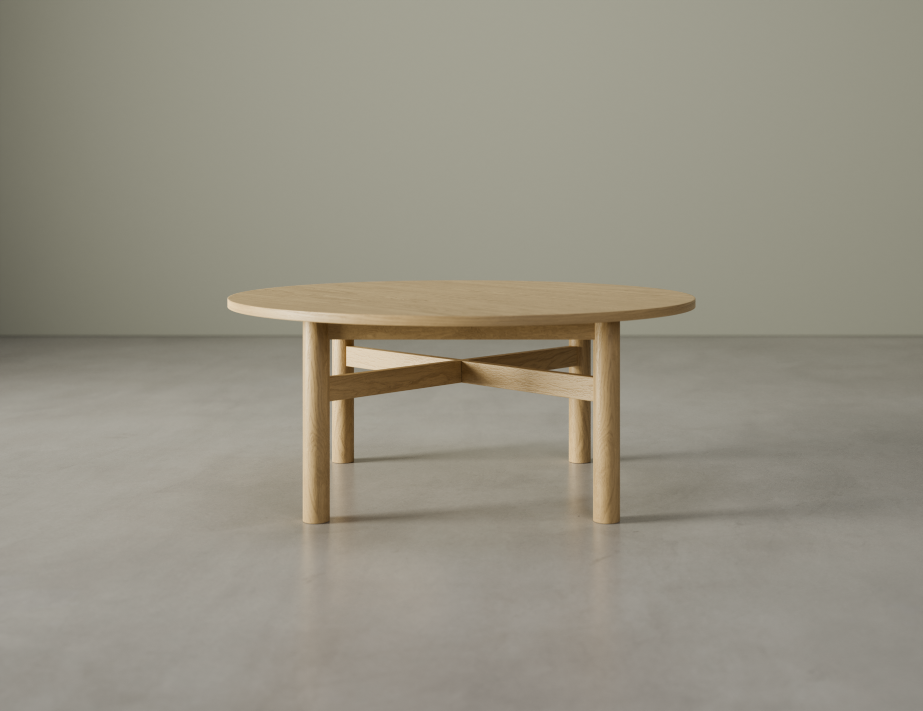 Nordica round wooden coffee table in natural oak finish on a polished concrete floor.