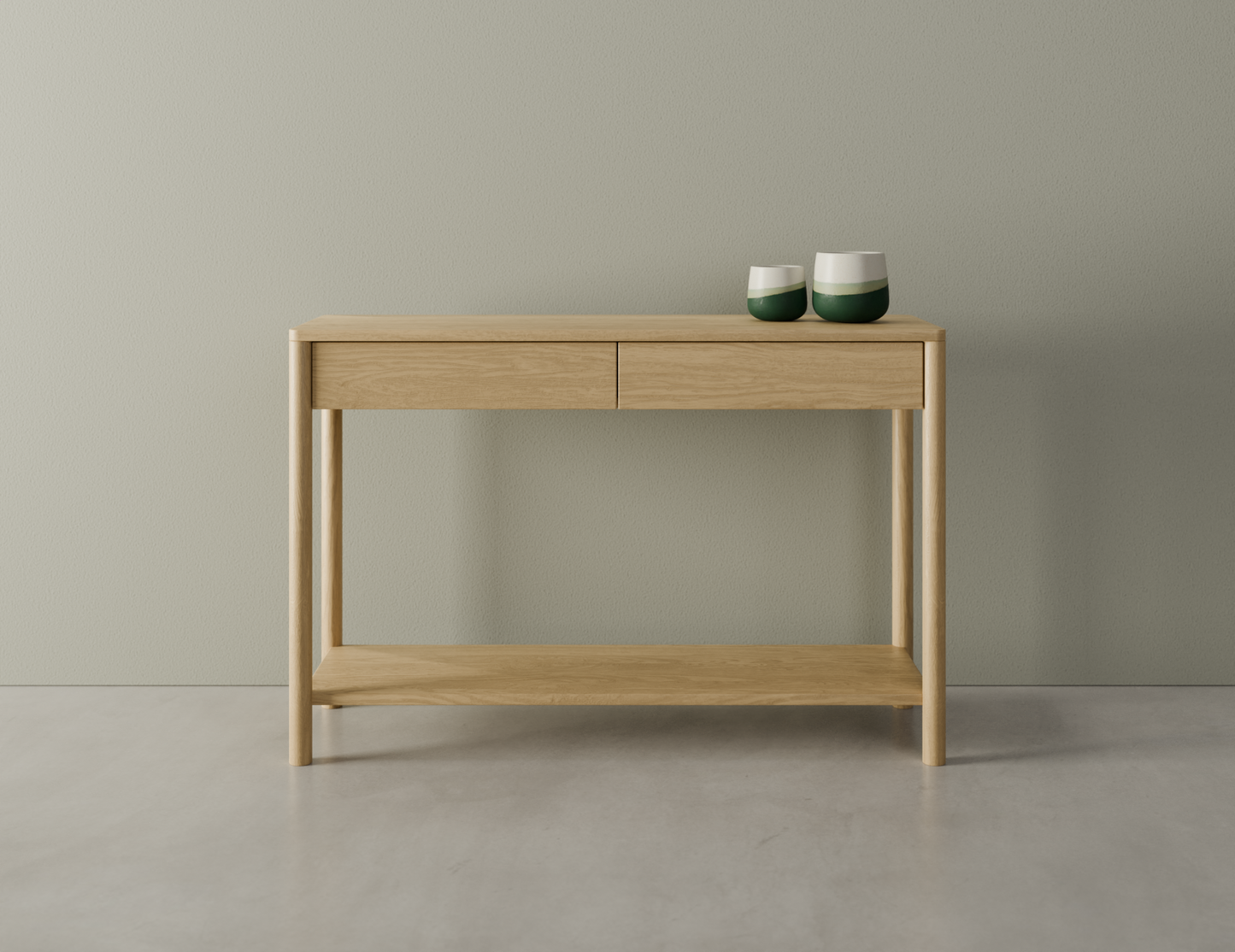 Nordica wooden console table in natural oak finish with 2 drawers displaying 2 ceramic ornaments on a polished concrete floor.
