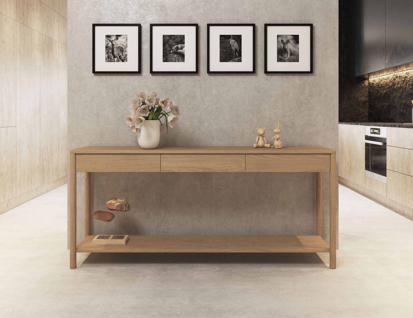 Nordica wooden console table in natural oak finish with 3 drawers against a concrete wall with 4 pictures hanging above in a modern house.