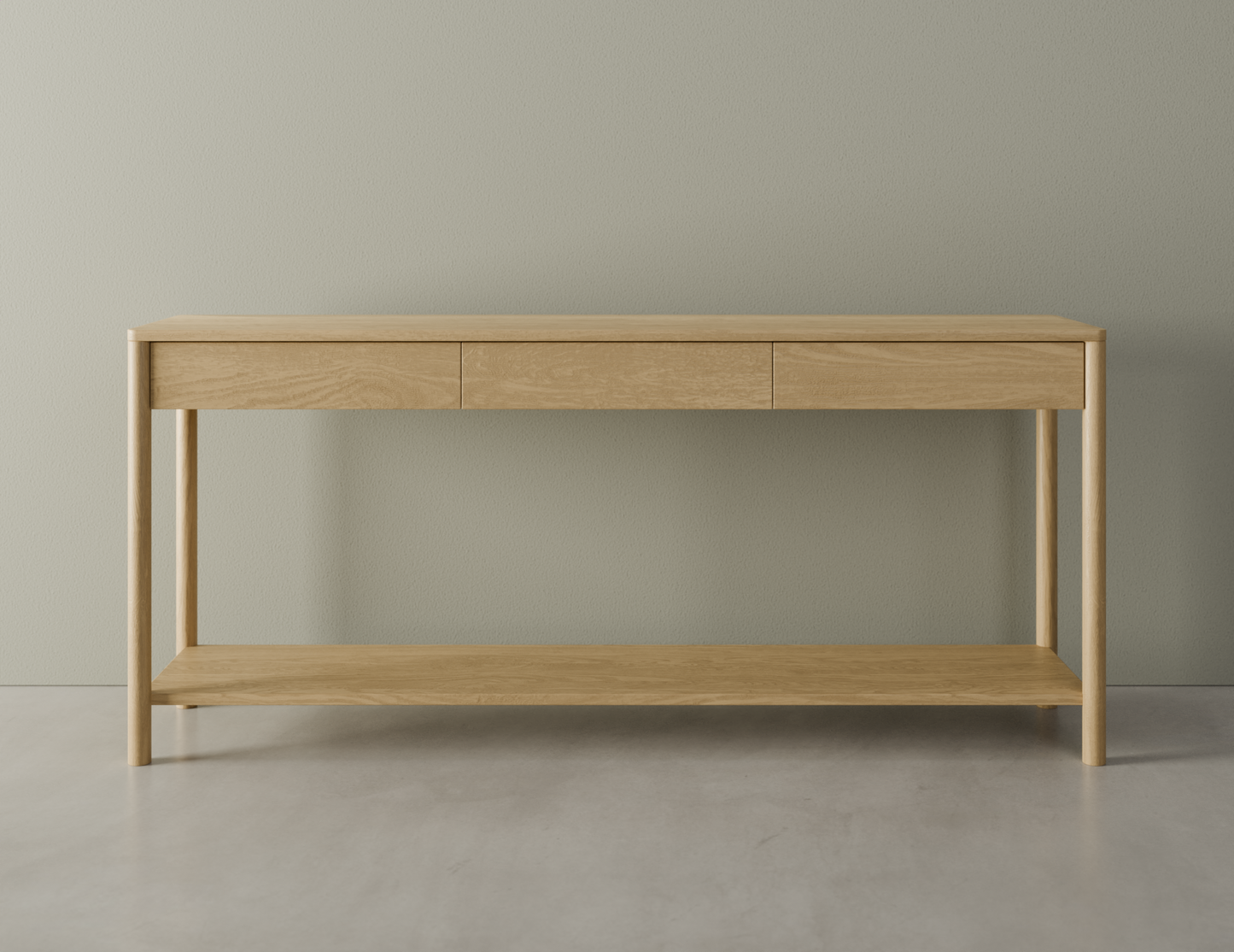 Front view of Nordica wooden console table in natural oak finish with 3 drawers on a polished concrete floor.
