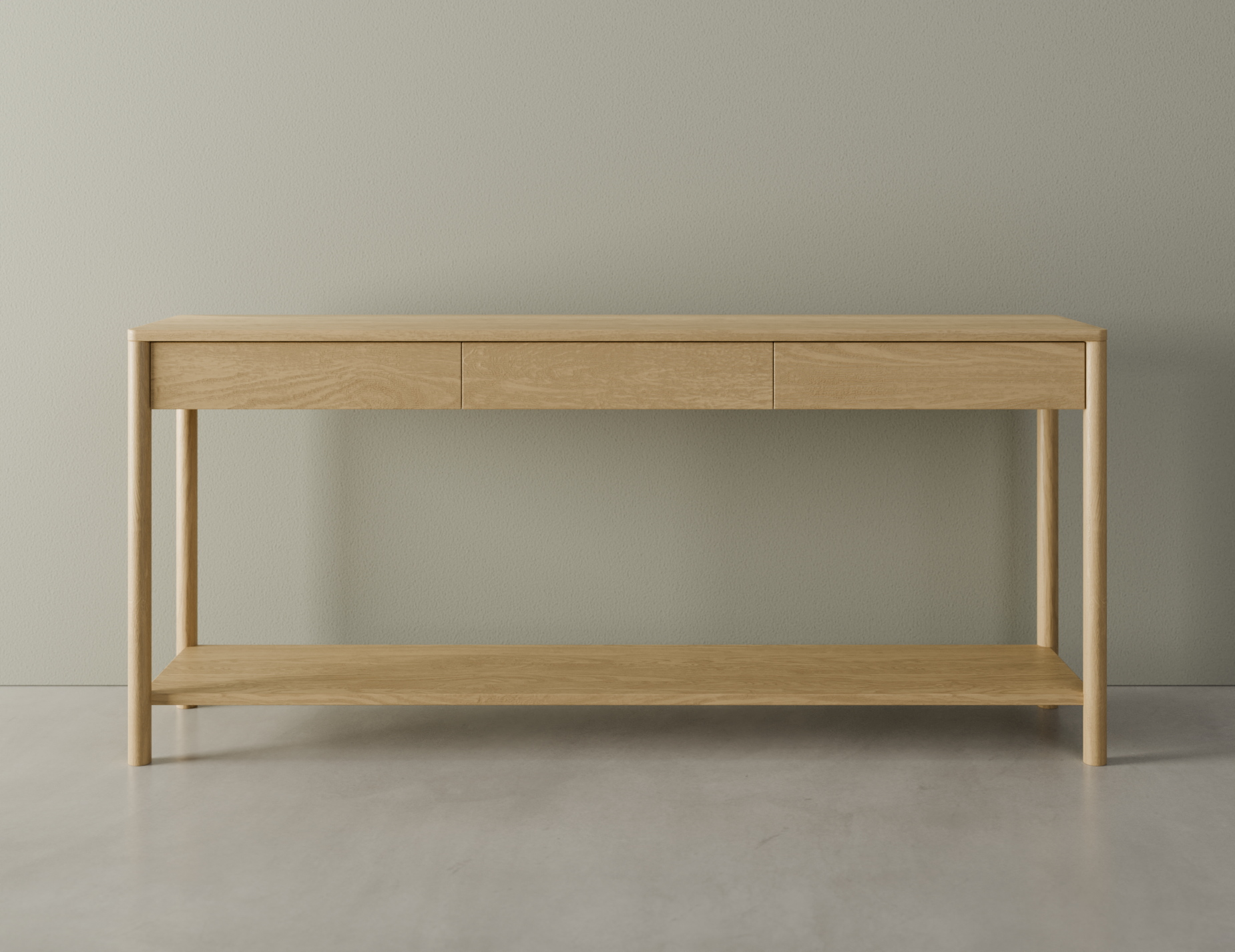 Front view of Nordica wooden console table in natural oak finish with 3 drawers on a polished concrete floor.