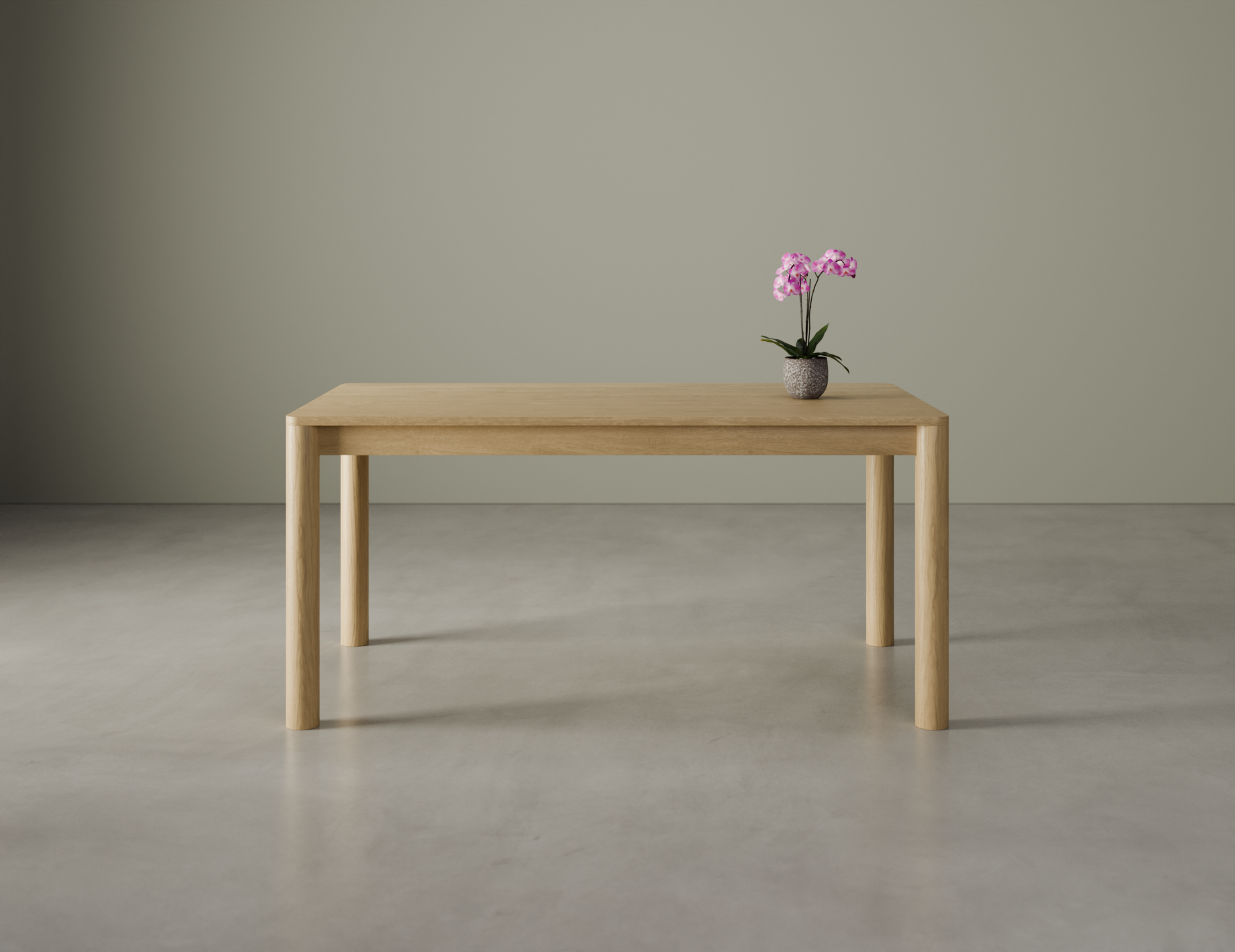 Front view of a small Nordica wooden dining table in natural oak finish with a flower in a vase on a polished concrete floor.