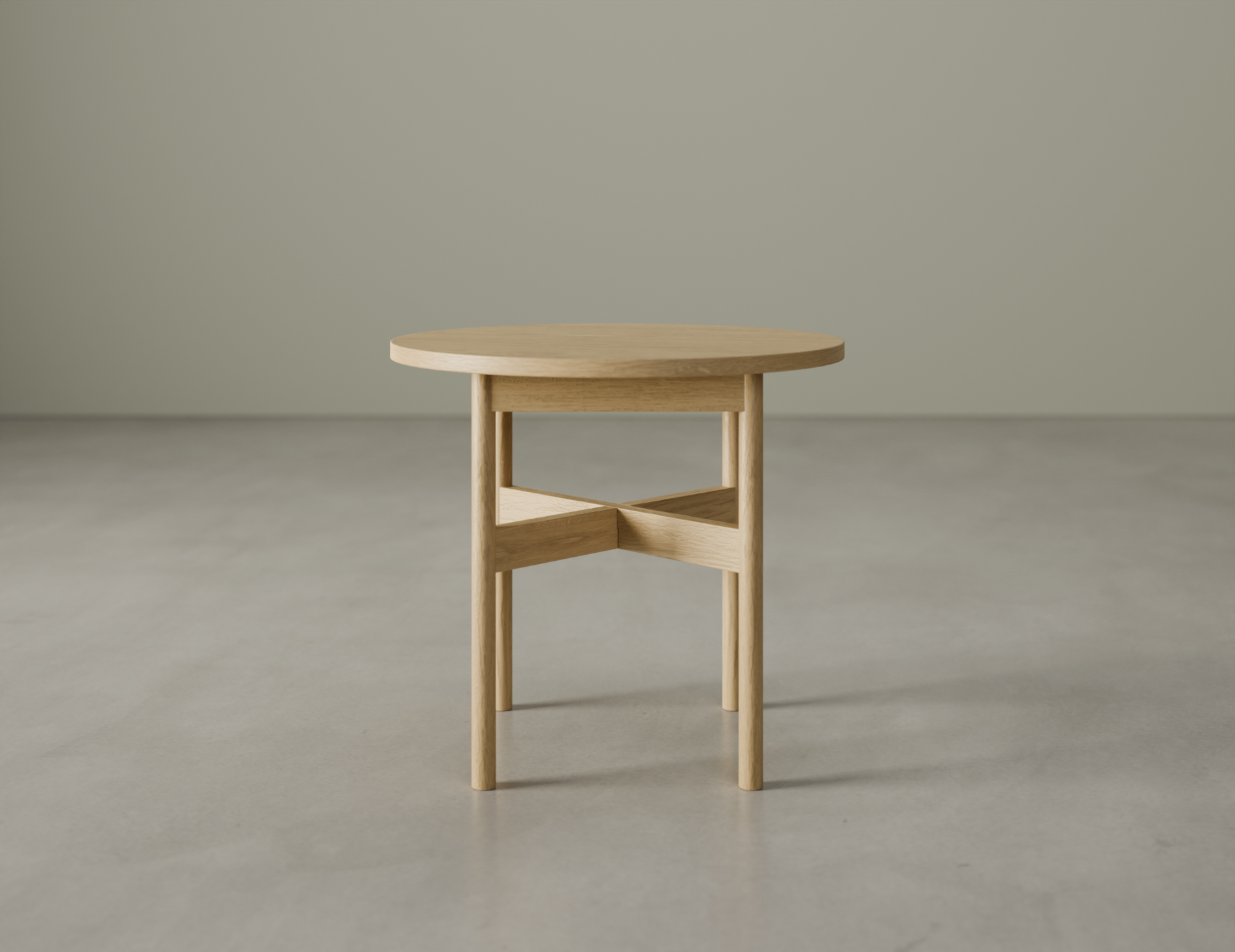 Round side table in natural wood finish on a polished concrete floor.