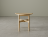 Round side table in natural wood finish on a polished concrete floor.
