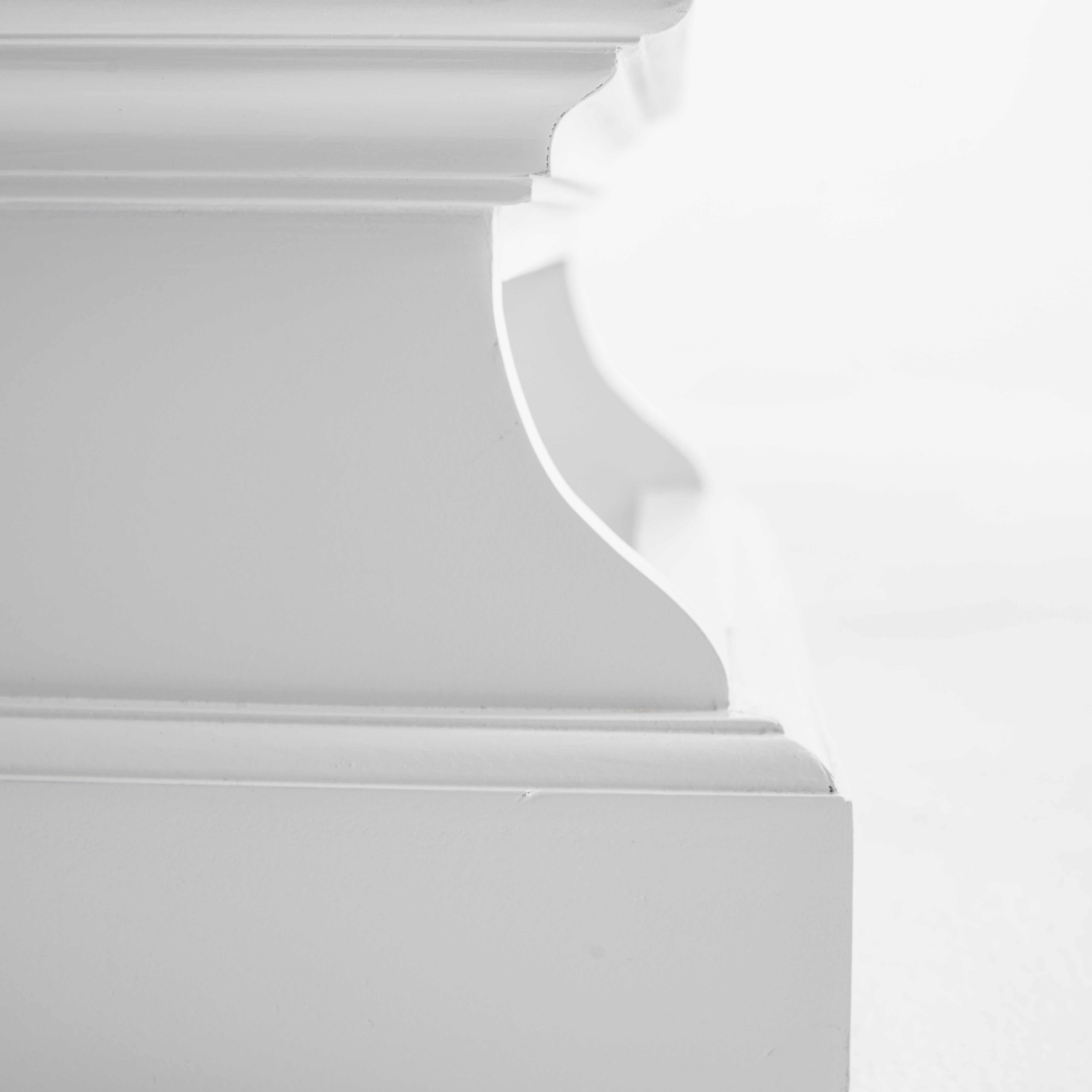 Close-up side view of a white timber bed step.