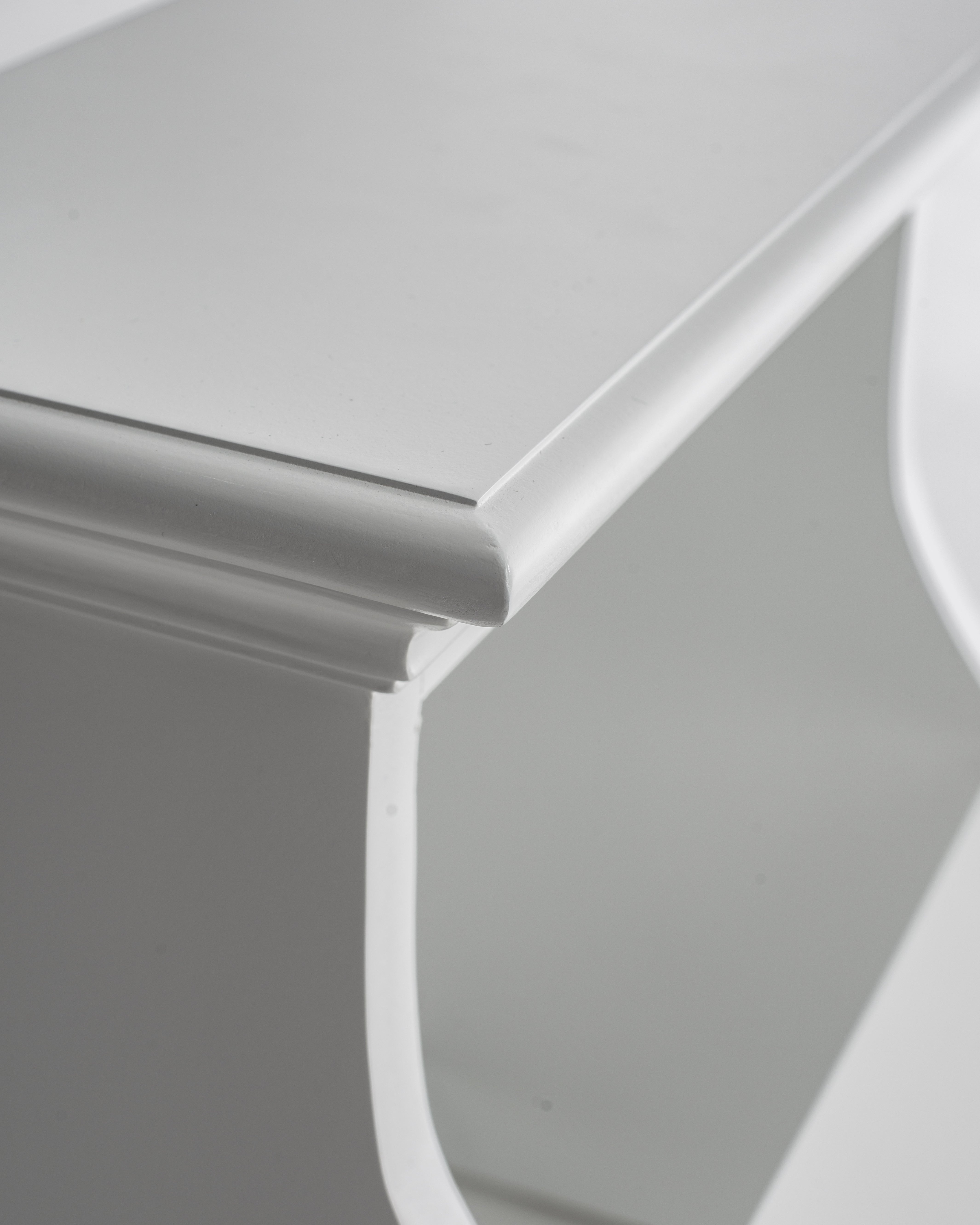 Close-up view of a white timber bed step corner.
