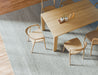 Overhead angled view of Pier Dining Table - Solid Oak - 160 cm x 90 cm styled with ceramic vases and dining chairs on textured rug.