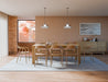 Lifestyle dining room view of Pier Dining Table - Solid Oak - 200 cm x 95 cm styled with six wooden dining chairs in a contemporary open-plan space.